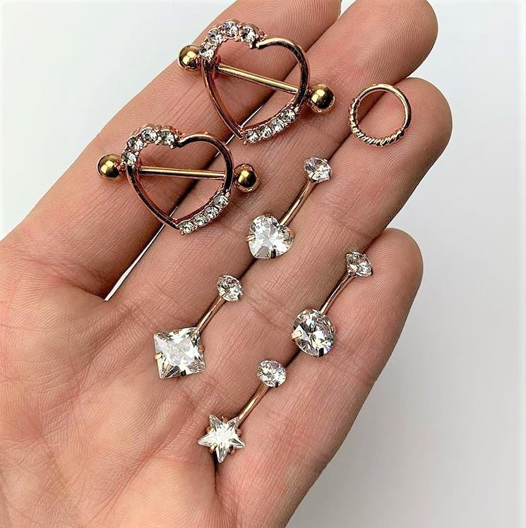 Set de protectores de pezón de 14G y 3/4 con gema transparente y corazón anodizado dorado